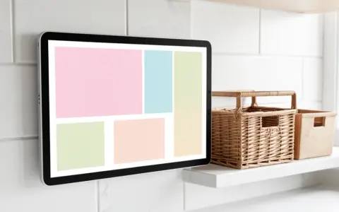Wall-mounted household tablet with simple color panels beside storage baskets