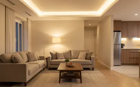 Living room with layered ceiling and floor lighting